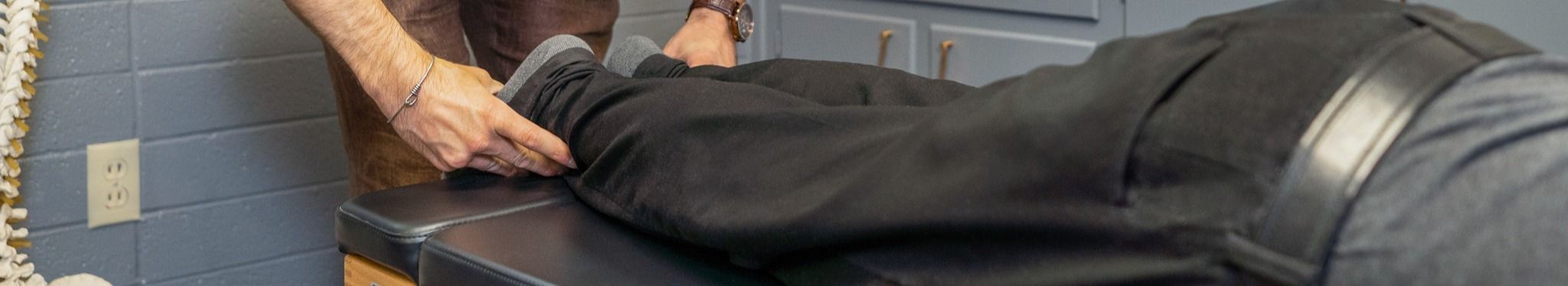 Chiropractor adjusting patient's feet
