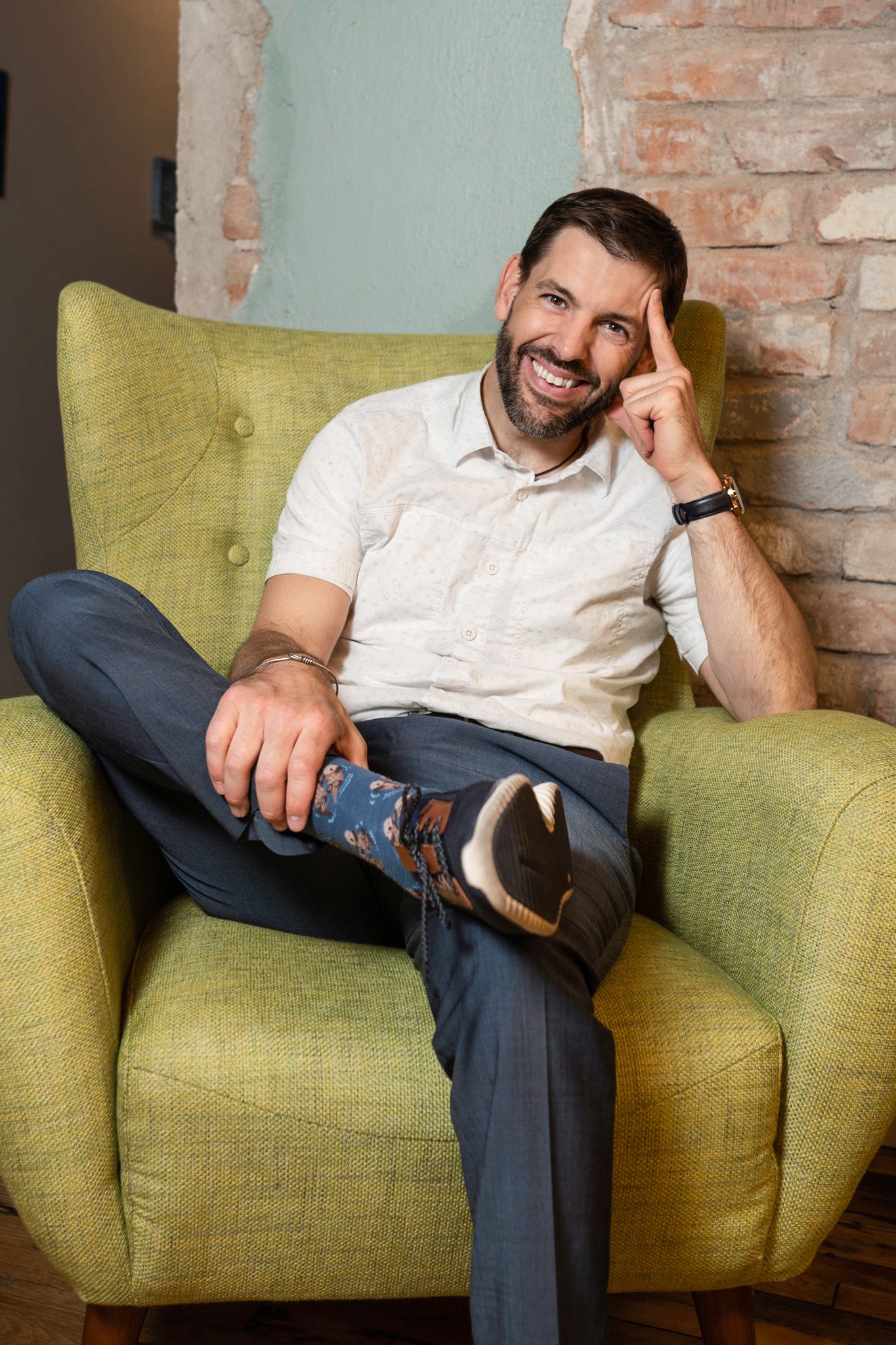 Dr. Clint Mausser seated in a green armchair