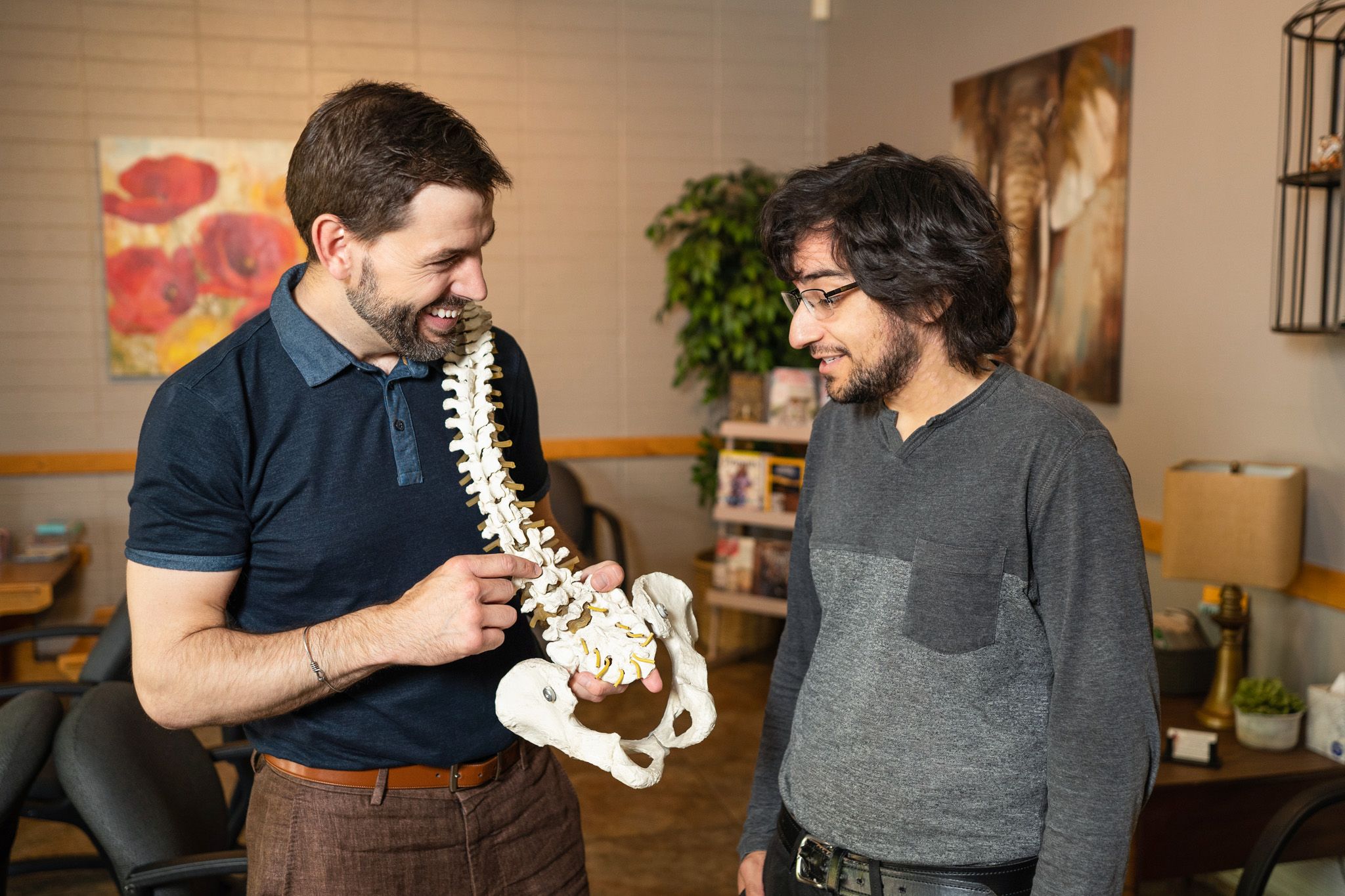 Dr. Clint Mausser showing a spine model to a patient